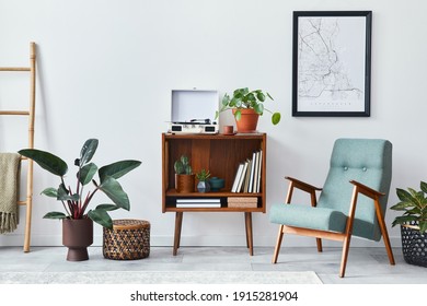 Modern retro composition of living room interior with design wooden cabinet, stylish armchair, mock up poster map, plants, vinyl recorder, books and personal accessories in home decor. Template. - Shutterstock ID 1915281904