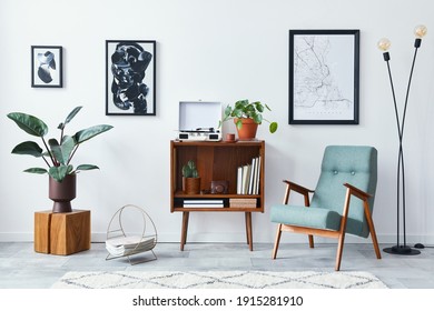 Modern retro composition of living room interior with design wooden cabinet, stylish armchair, mock up poster map, plants, vinyl recorder, books and personal accessories in home decor. Template. - Shutterstock ID 1915281910