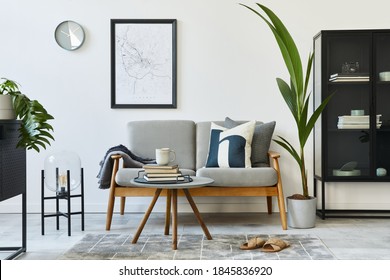 Modern retro concept of home interior with design grey sofa, coffee table, plants, furniture, mock up poster map, decoration and personal accessoreis. Stylish home decor of living room. - Shutterstock ID 1845836920