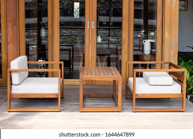 Modern Riverside Cafe With Wooden Sofa And Furniture.