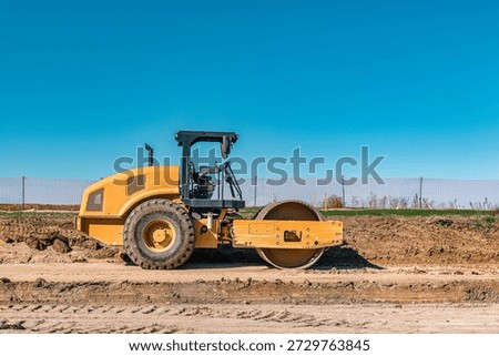 Modern road roller working under clear blue sky, symbolizing precision, trust, and professional compaction solutions for large-scale construction and infrastructure development.