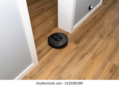 A Modern Robotic Vacuum Cleaner Running On Vinyl Panels, An Autonomous Cleaning Robot.