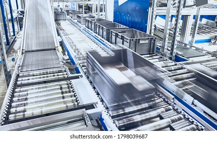 Modern roller conveyor system with boxes in motion, shallow depth of field.