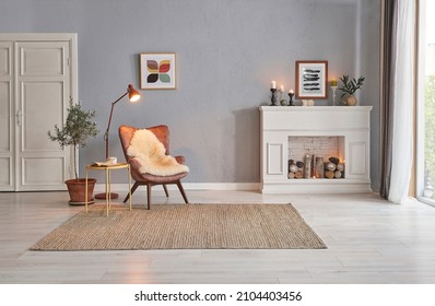 Modern room concept interior style, chair fireplace frame wicker carpet decoration, grey stone wall background. - Shutterstock ID 2104403456