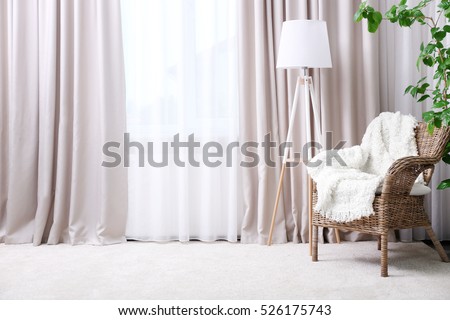 Modern room interior with armchair and curtains