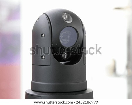 Modern rotating CCTV security camera lens closeup