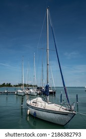 Modern Sail Boat Anchors In Calm Harbor On Lake Balaton In Hungary