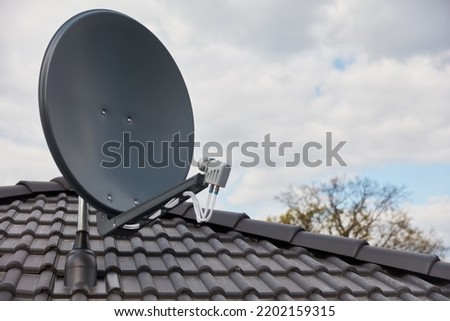 Modern satellite dish on the roof of the house for satellite reception