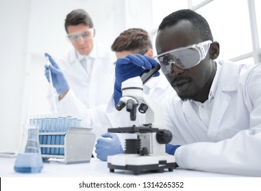 modern-scientist-looking-through-microscope-260nw-1314265352.jpg