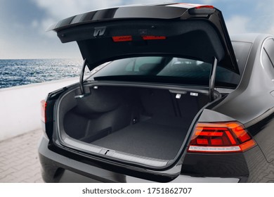 Modern sedan car have an open trunk. The car boot is open and ready for luggage loading. Empty space at the boot of the sedan car. Rental car service