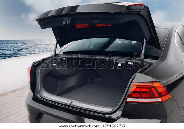 Modern\
sedan car open trunk. Car boot is open and ready for luggage\
loading. Empty space at the boot of sedan\
car