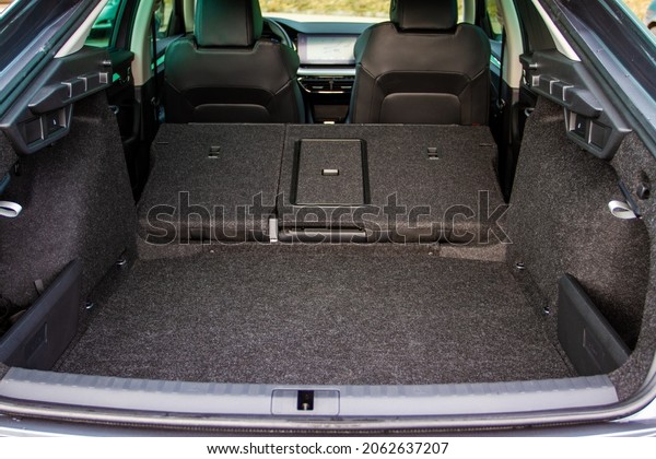 Modern sedan car open trunk. Huge, clean\
and empty car trunk in interior of modern\
car.