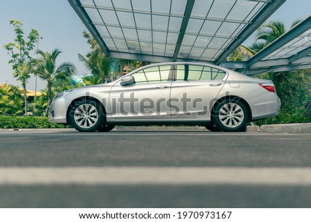 modern sedan car at outdoor parking lot with transparent roof, car parking shed at garage, selective focus