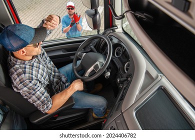 Modern Semi Truck Vehicle Driver Talking To His Truck Dispatcher Making Sure Deliver Will Be Made In Time.