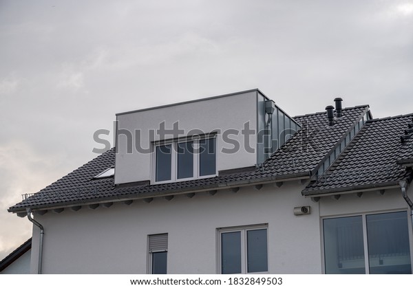 modern semi-detached house with flat roof dormer\
with aluminum cladding