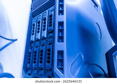 A modern server tower illuminated with blue lighting, showcasing advanced technology and design for data processing and storage in IT environments.