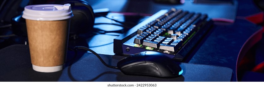 modern set-up with a sleek computer keyboard and mouse on a table next to a cup of coffee,banner