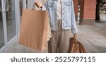 Modern Shopper Displaying Large Shopping Bags Post Black Friday Purchases