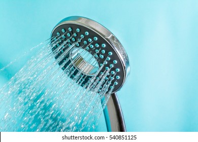 Modern Shower With Stream Of Water Close Up On A Blue Background