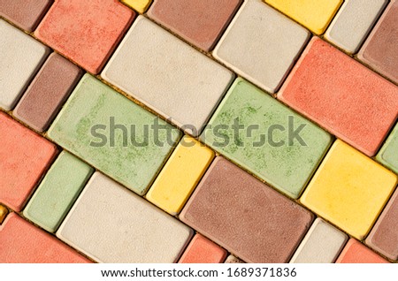 Modern sidewalk with multi-colored tiles of different sizes
