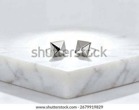 Modern Silver Stud Earrings on Marble Block