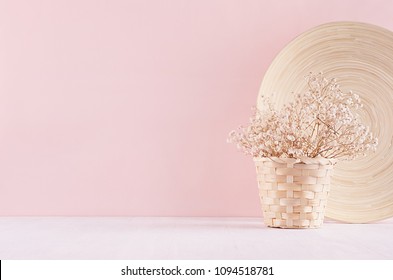 Modern simple art pink home decor with white dried flowers, bamboo dish on soft light white wood table. 