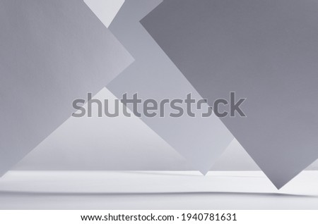 Modern simple geometric white grey abstract background with asymmetric standing papers with perspective, light and shadow, stripes as frame, copy space.