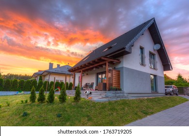 A Modern Single Family House With A Garden At Sunset