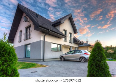 A Modern Single Family House With A Garden At Sunset