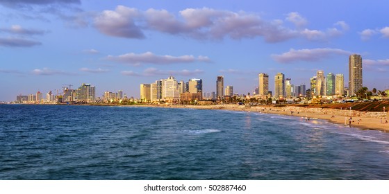 Modern skyline and sand beaches of Tel Aviv city on sunset, Israel
