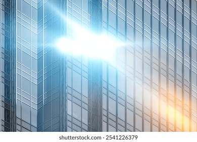 A modern skyscraper with a bright sun flare reflecting off the glass windows. - Powered by Shutterstock