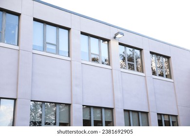 modern skyscraper, with large windows, represents the towering presence of business and commercial real estate in the urban landscape, blending elegance and functionality