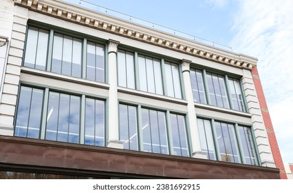 modern skyscraper, with large windows, represents the towering presence of business and commercial real estate in the urban landscape, blending elegance and functionality