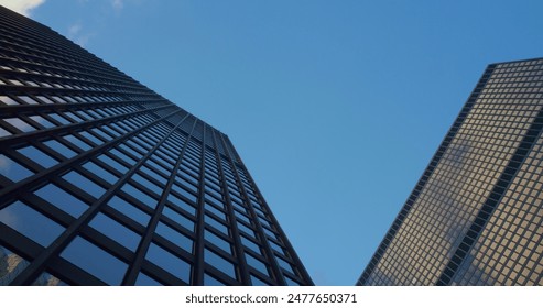 Modern skyscrapers in cityscape with reflective windows under clear blue sky. Concept skyscrapers, modern architecture, urban environment, reflection, tall buildings. downtown minimalist design. - Powered by Shutterstock