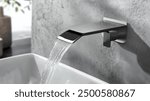 Modern and sleek wall-mounted waterfall faucet with a minimalist design, flowing gracefully into a pristine white basin. Ideal for luxury bathrooms, blending functionality with contemporary elegance