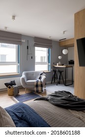 Modern And Small Studio Apartment With Bedroom Open To Kitchen And Cozy Armchair