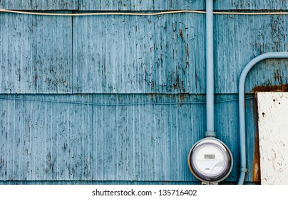 Modern Smart Grid Residential Digital Power Supply Meter Mounted On Grungy Blue Exterior Wooden Wall