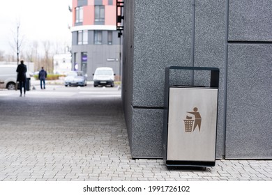 A modern smart trash can on the street.