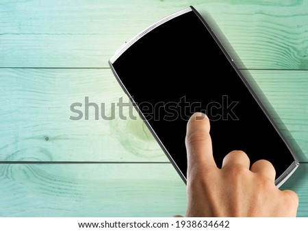 Modern smartphone with a blank screen on the desk
