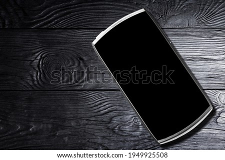 Modern smartphone with a blank screen on the desk
