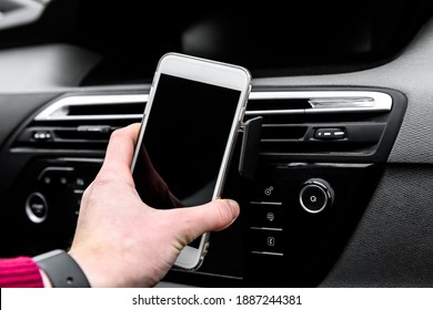 Modern Smartphone Device Gadget Mounted On Phone Holder At Car Dashboard. 