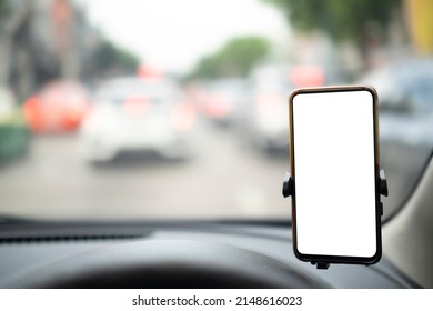 Modern smartphone device gadget mounted on phone holder at car dashboard. Mock-up white screen isolated template. Copyspace for text. Vehicle interior cockpit view. Traffi jam info app - Powered by Shutterstock