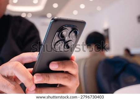 Modern Smartphone User Browsing Mobile Apps in Coffee Shop