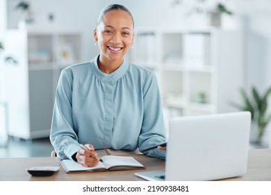 Modern, smiling and young business woman enjoying her work in a office at a computer indoors. Portrait of a happy junior corporate lawyer working, making notes and planning a successful job strategy - Shutterstock ID 2190938481