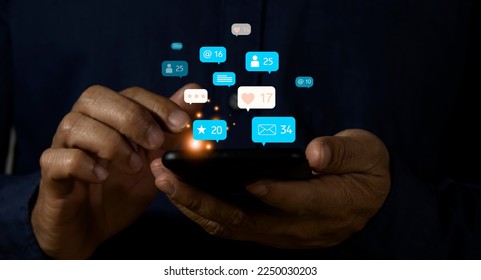 Modern social media marketing concept on mobile phone with notification icons such as, message, comment and star above smartphone screen - Shutterstock ID 2250030203