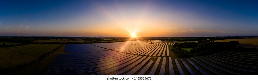 Modern Solar Farm Panoramic At Sunrise On A Summers Day