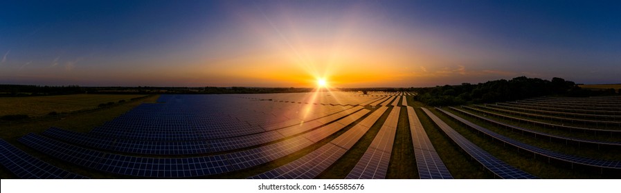 Modern Solar Farm Panoramic At Sunrise On A Summers Day