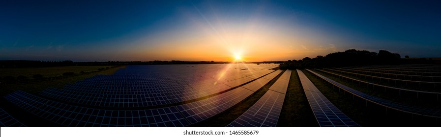 Modern Solar Farm Panoramic At Sunrise On A Summers Day