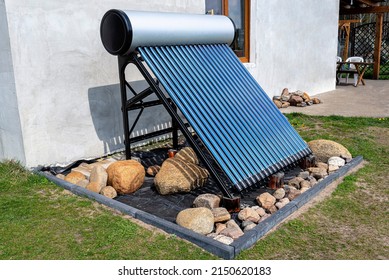 A Modern Solar Pressure Collector To Heat Domestic Hot Water, Standing In Front Of The House On The Lawn.