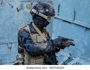 Modern Soldier In Black Multicam Uniform With Rifle, Urban Background 